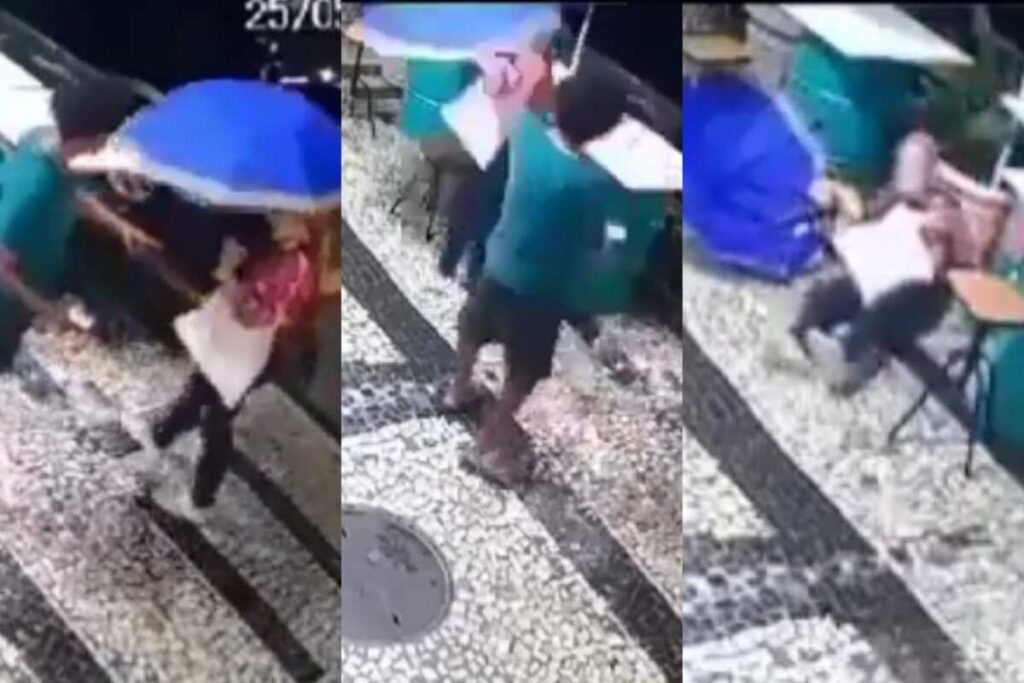 Antes da agressão, morador de rua estende a mão em direção à idosa, para tentar vender algum produto ou pedir dinheiro. (Foto: captura)