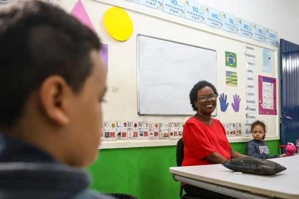 foto de professora dando aula com olhar atendo de aluno