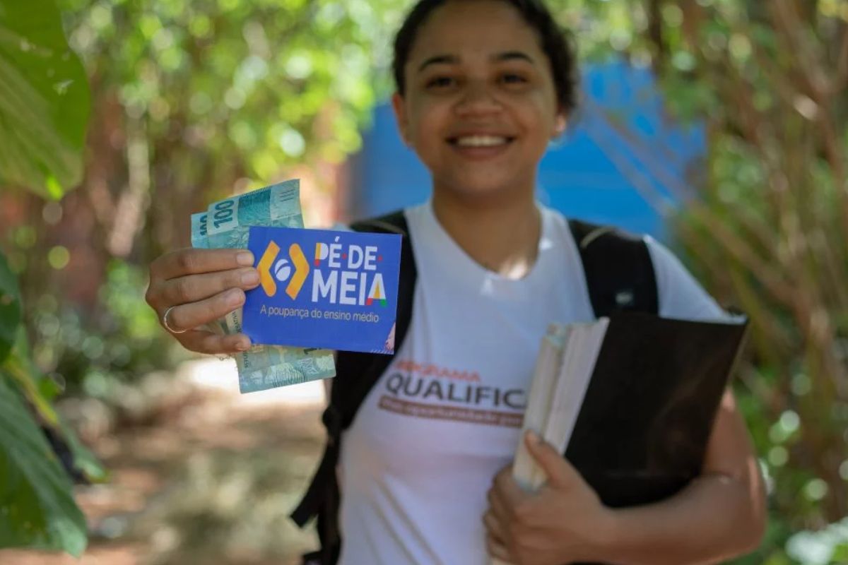 foto de estudante segurando cartão do pé-de-meia