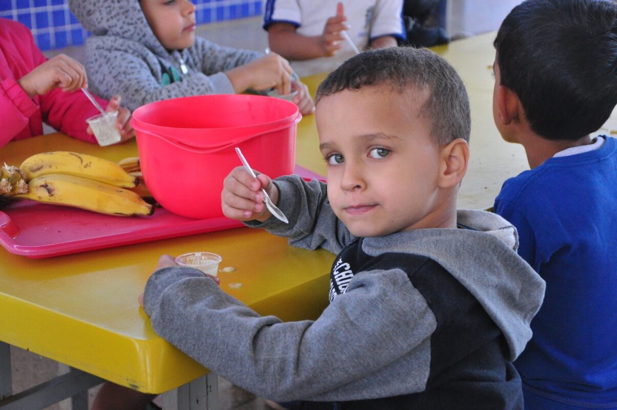 foto de estudante comendo merenda escolar